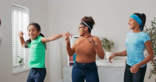 Happy Family Dancing Together in Living Room