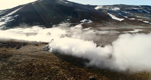 drone flying straight into the steam of a fumarole in Iceland, slow motion