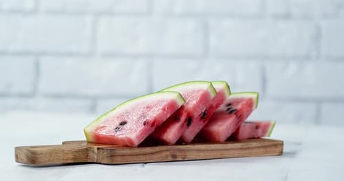 Pieces of Ripe Watermelon on Cutting Board Slowly Rotate.