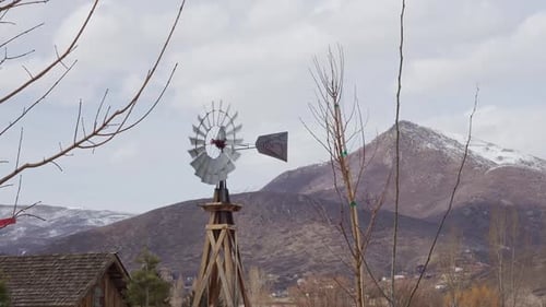 Windmill blowing in the breeze looking towards mountain