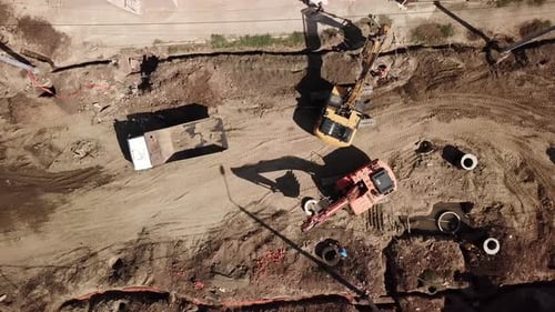 Aerial View of Excavators Loading Truck on Construction Site