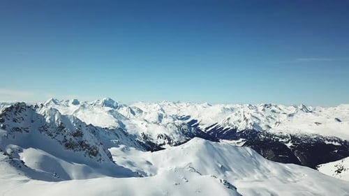 Aerial drone view of snow covered mountains in the winter.