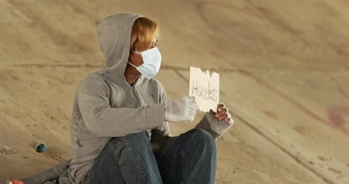 Homeless man holding homeless label