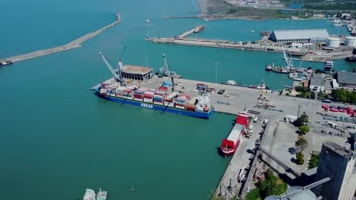 Aerial top view of cargo ship standing in the port