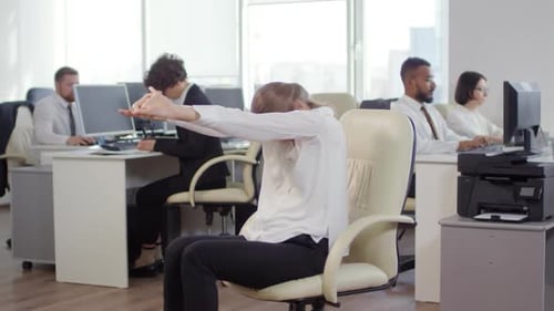 Beautiful Businesswoman Stretching in Office