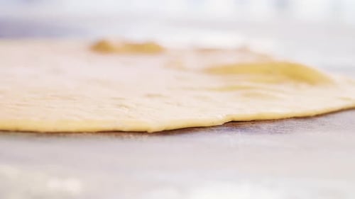 Rolling Pin Smoothing Pale Dough in Close Up