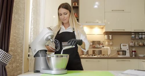 Woman Prepares Batter in Kitchen with Stand Mixer