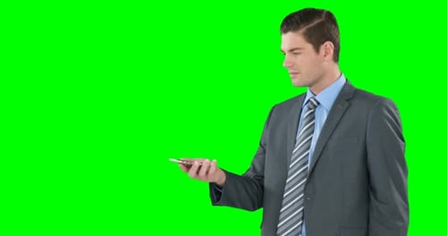 Man in Suit Using Smartphone on Green Screen