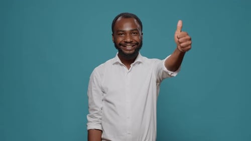 Man Gives Thumbs Up on Blue Background