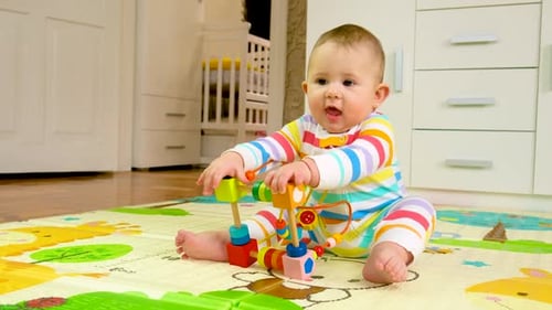 Baby Playing with Colorful Wooden Toy Indoors