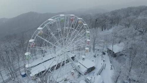 Ferris Wheel on Top of Mount Akhun During a Snowfall