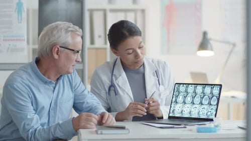 Doctor Discussing Brain Scan With Senior Patient