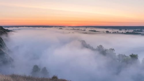 Timelapse Mist Curling Over River and Meadow on Sunrise Background