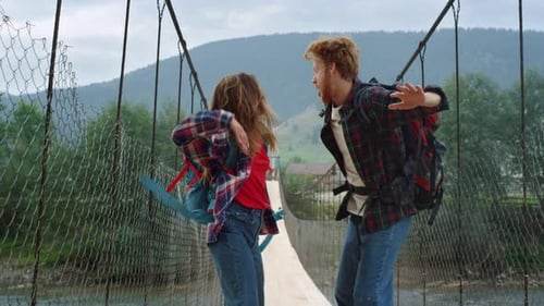 Two Hitchhikers Enjoy Jump on Mountains River Bridge