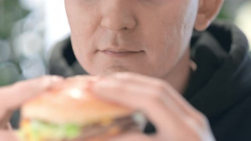 Mouth Close Up Man Student Eats Burger at Fast Food Restaurant Juicy Delicious Big Burger with Meat