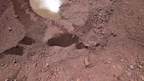 A Crack on a Glacier Covered with Rocks