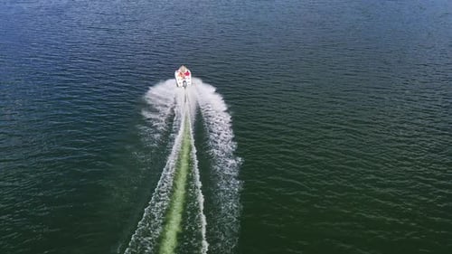 Aerial view of boat on river. Drone view of motor boat sailing on river