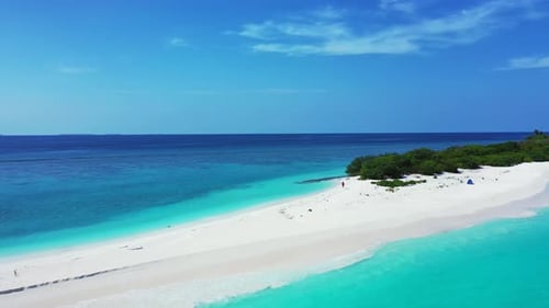 Wide angle drone tourism shot of a sandy white paradise beach and blue water background in high reso