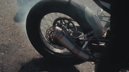 Motorcycle Wheel Spinning and Smoking on Asphalt