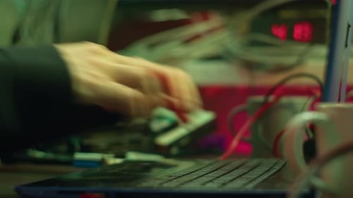 Professional Hacker Typing on Keyboard at Night Closeup of Man Hands Trying to Break Password Using