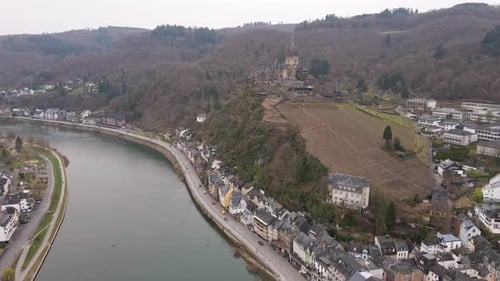 drone flight towards the castle of cochem over the river Moselle with a view over this incredibly b