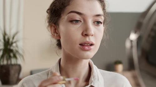 Woman Applying Lip Gloss