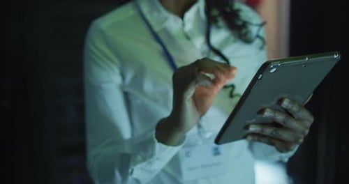 Close Up Person Using Tablet in Server Room