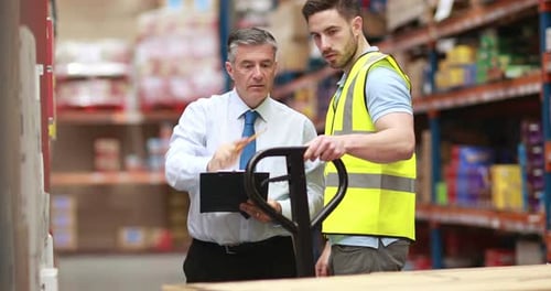 Warehouse worker talking with his manager