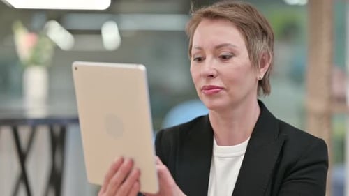 Adult Woman Uses Tablet Device Indoors