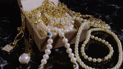 Elegant Gold Chains and Pearl Necklaces Still Life