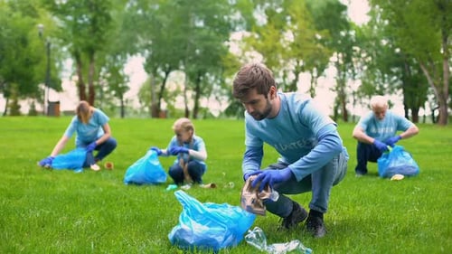 Group of Volunteers Picking Up Litter in Park