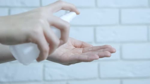 Woman Applies Hand Sanitizer for Cleaning Hands
