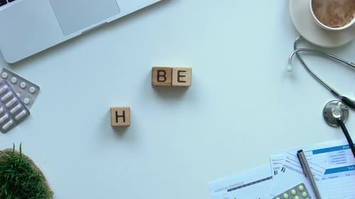 Blocks Spell "Be Healthy" on a White Desk