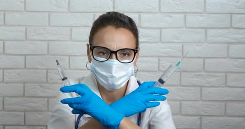 Woman Doctor with Syringes Wearing Mask and Gloves
