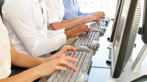 Business people typing in a row