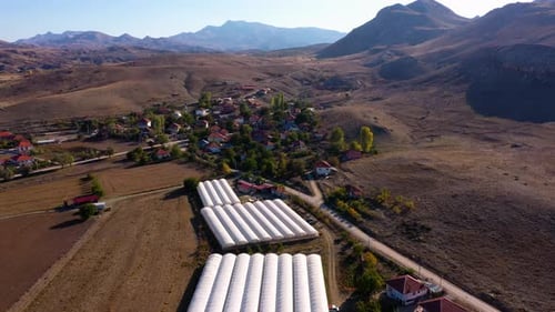 Panoramic Aerial View of Mountain Valley with Village and Farmlands