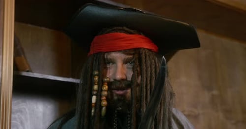 Man Wearing Pirate Costume Holding Sword Laughing