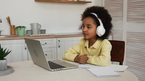 Girl Attends Online Class at Home Using Laptop