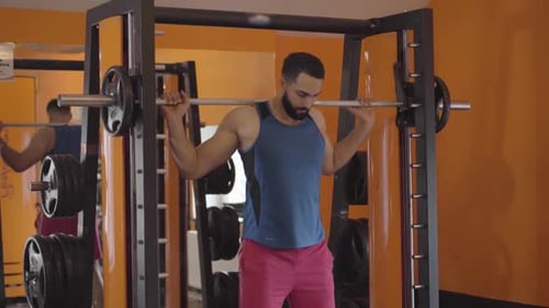 Young Sportive Middle Eastern Man Lifting Weights in Gym. Portrait of Handsome Sportsman Training in