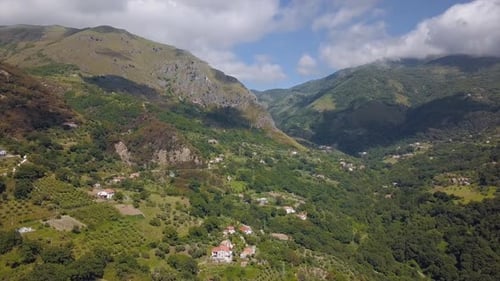 Aerial View of Mountain Gorge Hills Covered with Green Forest. Italian Landscape Sunny Weather