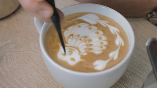 Barista Creating Peacock Latte Art Design