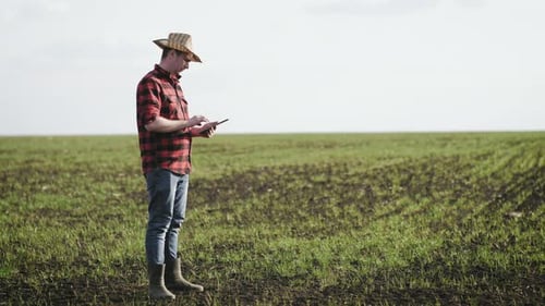 Farmer Using Tablet in Rural Green Field