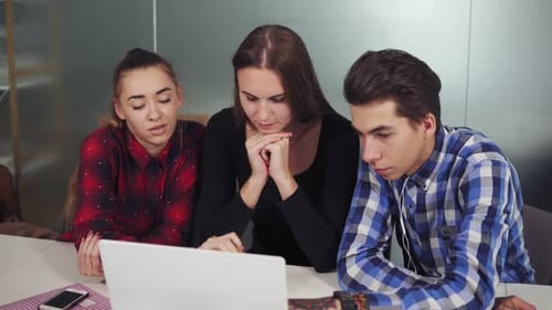 Group of Young Creative Workers in a Creative Start Up Work Environment Holding a Project Meeting