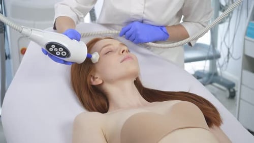 Woman Receiving Facial Treatment in Medical Clinic