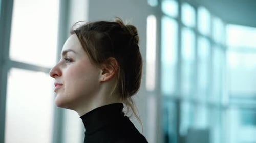 Woman Meditating in Modern Workplace Environment