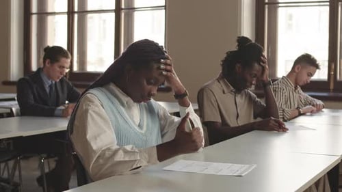 Stressed Students Taking an Exam in Classroom