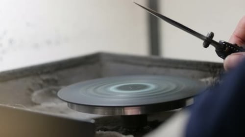 Sharpening Metal Blade on Rotating Grinding Disc