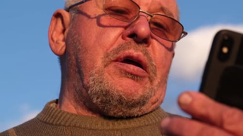 Senior Man Talking on Smartphone Outdoors Close Up