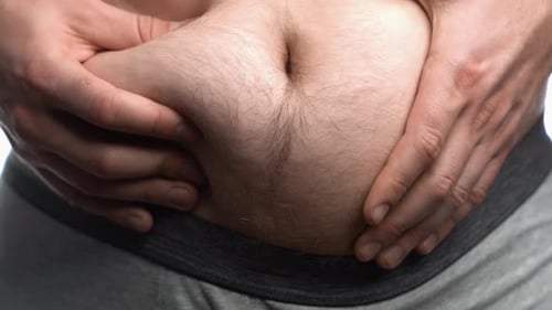 Man Holding Stomach Close Up