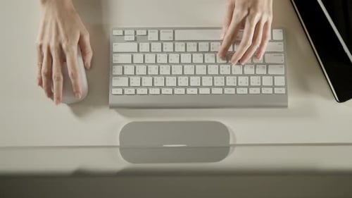 Hands Typing on Keyboard at Minimalist Desk